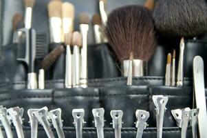 a black leather case with many brushes and other tools photo