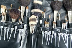 a black leather case with many brushes and other tools photo