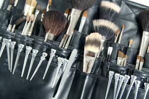 a black leather case with many brushes and other tools photo