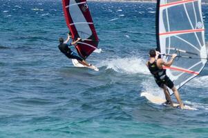 a man windsurfing in the ocean photo