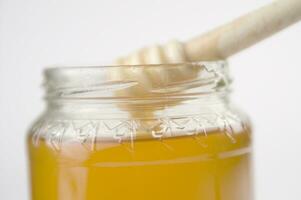 honey dripping from a wooden stick photo