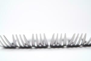 many forks and knives are arranged in a pile photo