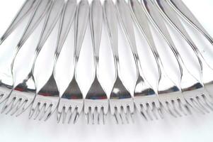 many forks and knives are arranged in a pile photo