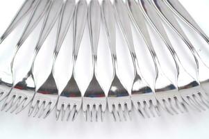 many forks and knives are arranged in a pile photo