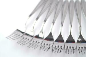 many forks and knives are arranged in a pile photo