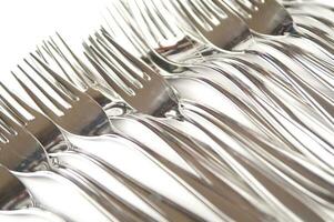 many forks and knives are arranged in a pile photo