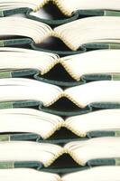 a stack of open books with green and gold trim photo