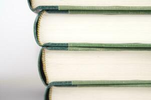 a stack of open books with green and gold trim photo