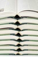 a stack of open books with green and gold trim photo