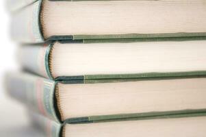 a stack of open books with green and gold trim photo