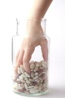 a jar of beans and a glass jar with beans photo