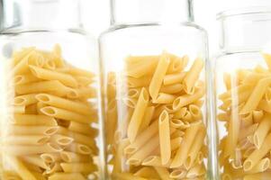 three glass jars filled with pasta photo