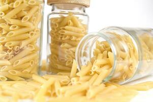 three glass jars filled with pasta photo