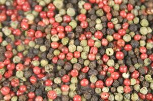 a close up of a pile of red and green peppers photo