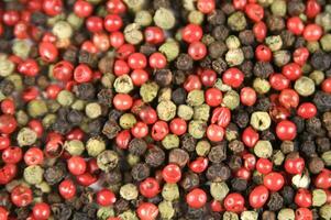 a close up of a pile of red and green peppers photo