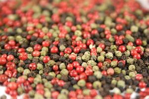 a close up of a pile of red and green peppers photo