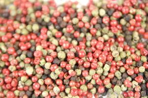 a close up of a pile of red and green peppers photo