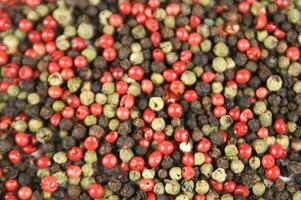 a close up of a pile of red and green peppers photo