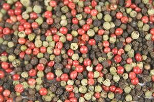 a close up of a pile of red and green peppers photo