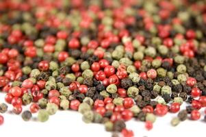 a close up of a pile of red and green peppers photo