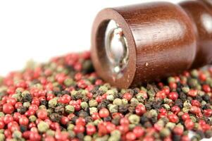 a close up of a pile of red and green peppers photo