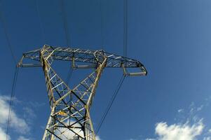 a large electrical tower with wires and wires photo