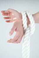 a woman's hands are tied to a rope photo