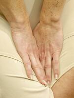 a woman is holding her stomach photo