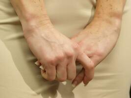 a woman is holding her stomach photo