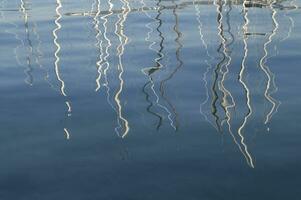 a reflection of a boat in the water photo