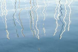 a reflection of a boat in the water photo