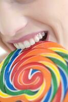 a woman holding a large lollipop photo