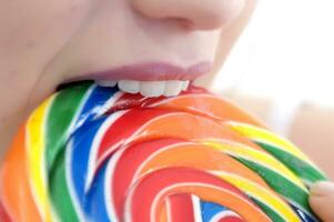 a woman holding a large lollipop photo