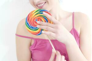a woman holding a large lollipop photo