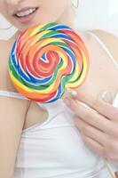 a woman holding a large lollipop photo