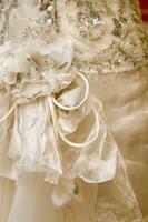 a close up of a wedding dress with a bow photo
