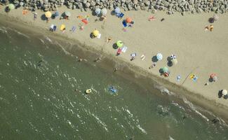 a beach with many people on it photo