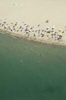 a beach with many people on it photo