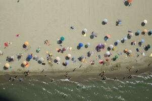 a beach with many people on it photo