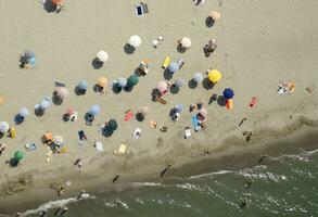 a beach with many people on it photo