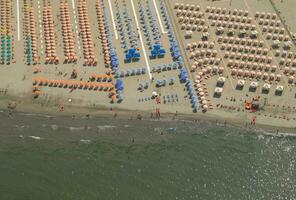 a beach with many people on it photo