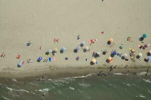 a beach with many people on it photo