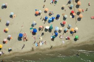 a beach with many people on it photo