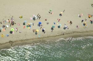 a beach with many people on it photo