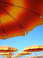 a row of orange and yellow umbrellas photo