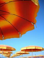 a row of orange and yellow umbrellas photo