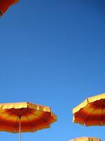 a row of orange and yellow umbrellas photo