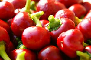 a bunch of red peppers sitting on a cloth photo