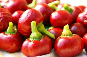 a bunch of red peppers sitting on a cloth photo