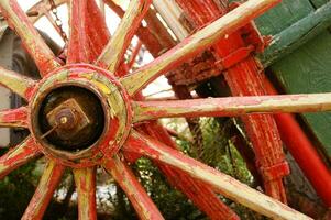 Ancient wooden wheel of an old wagon photo